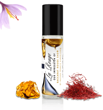 HauteBlends La Rouge pure perfume oil concentrate inspired by Baccarat Rouge 540 — 10ml travel-size clear glass rollerball bottle with a sleek black cap, styled against an artistic background of saffron and warm amber notes.