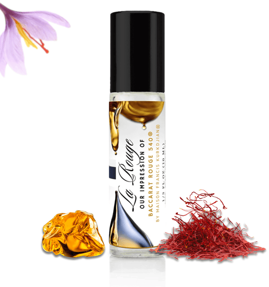 HauteBlends La Rouge pure perfume oil concentrate inspired by Baccarat Rouge 540 — 10ml travel-size clear glass rollerball bottle with a sleek black cap, styled against an artistic background of saffron and warm amber notes.